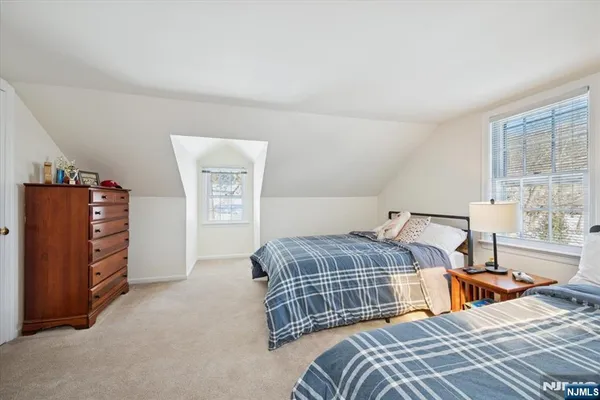 a bedroom with a bed and dresser