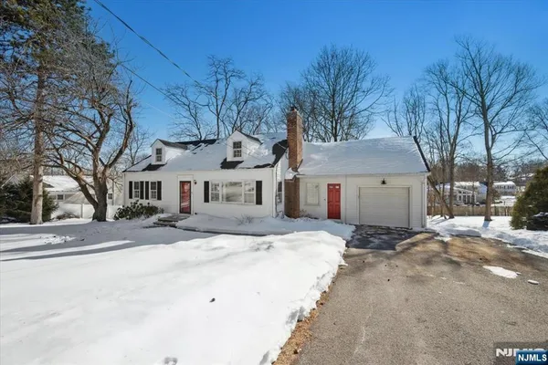 a view of a house with a yard covered in snow