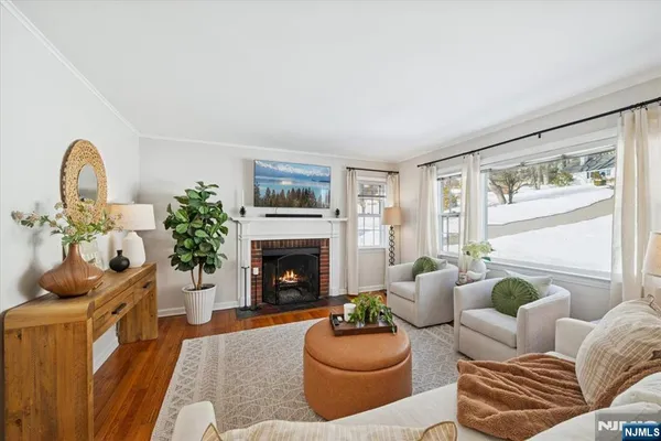 a living room with furniture fireplace and a large window