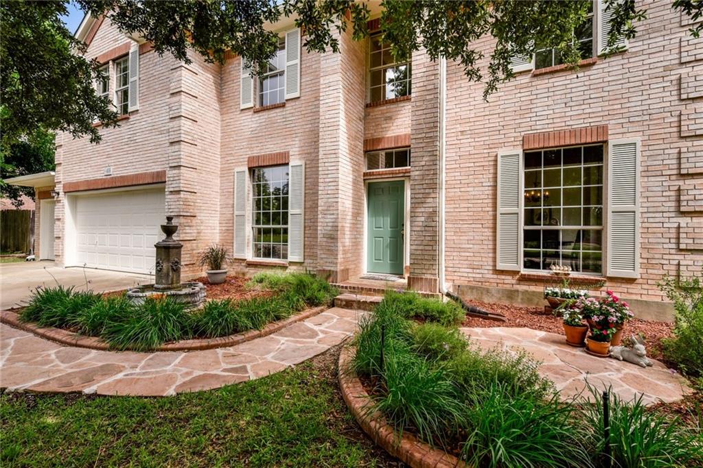 455 Logan Road Georgetown, TX 78628 - Photo 2 of 35 A classic brick facade welcomes with inviting landscaping, a flagstone pathway, and a charming fountain.