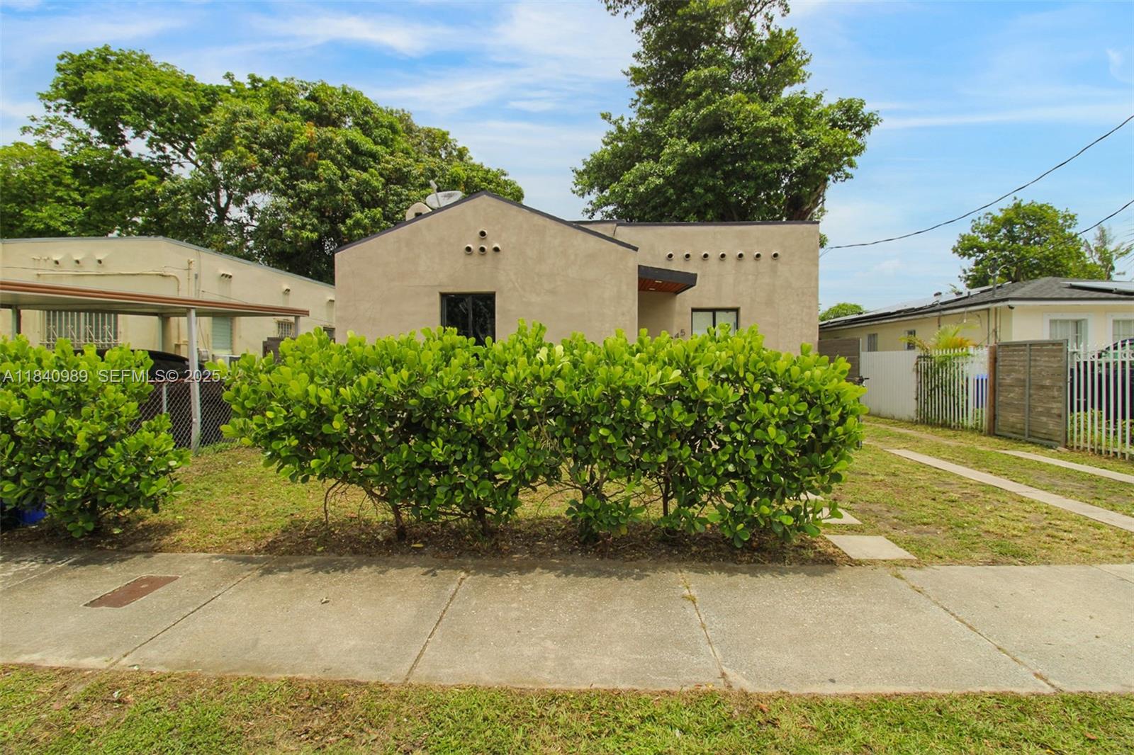 1745 Northwest 49th Street Miami, FL 33142 - Photo 2 of 30 a view of a house with a yard