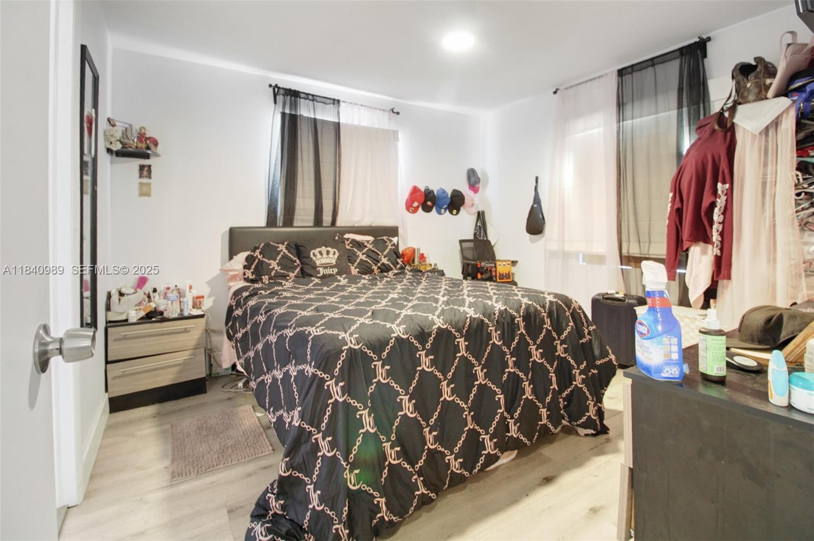 1745 Northwest 49th Street Miami, FL 33142 - Photo 21 of 30 a bed sitting in a bedroom next to a window and a lamp