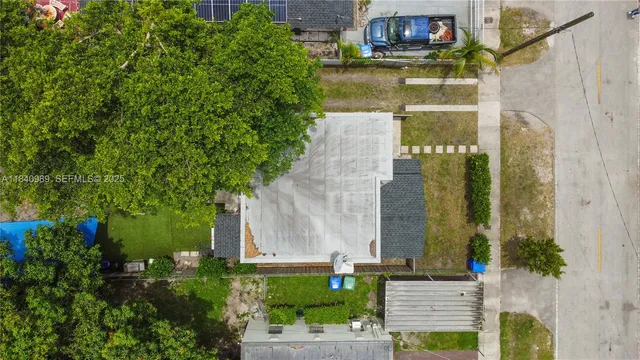 an aerial view of a house with a yard