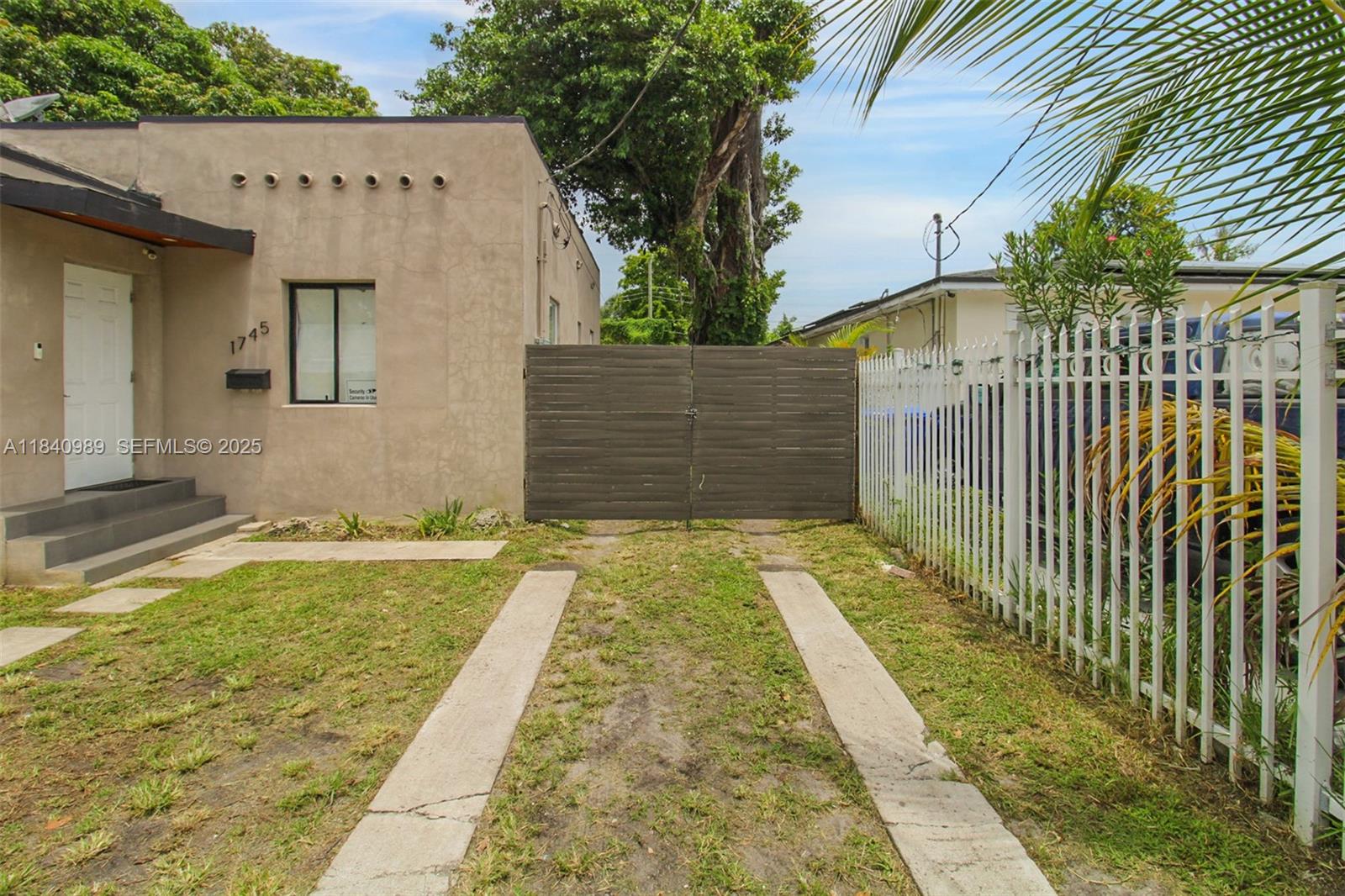 1745 Northwest 49th Street Miami, FL 33142 - Photo 6 of 30 a view of a backyard with wooden fence