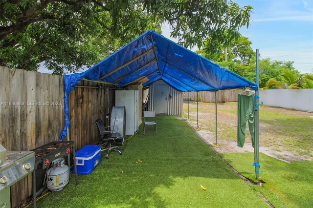 a view of a house with a backyard and a garage