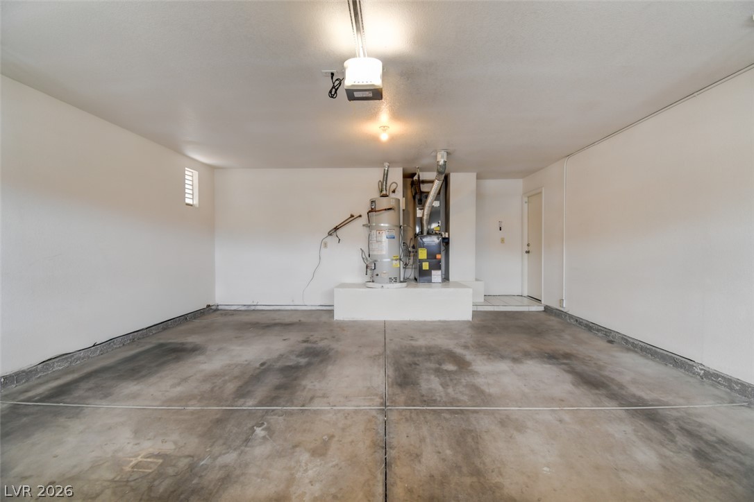5 Tarryall Terrace Henderson, NV 89074 - Photo 11 of 44 A well-maintained garage offers ample space with concrete flooring.
