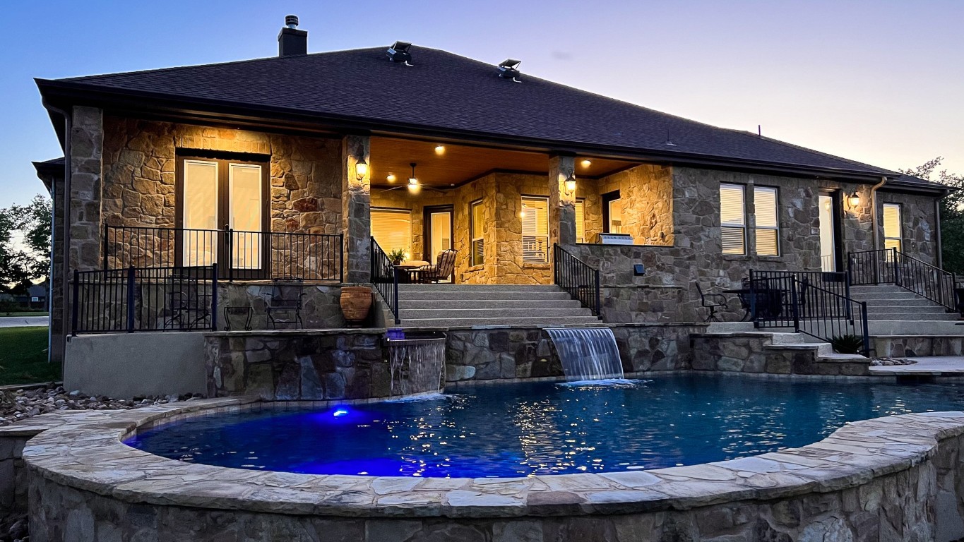 a view of house with swimming pool