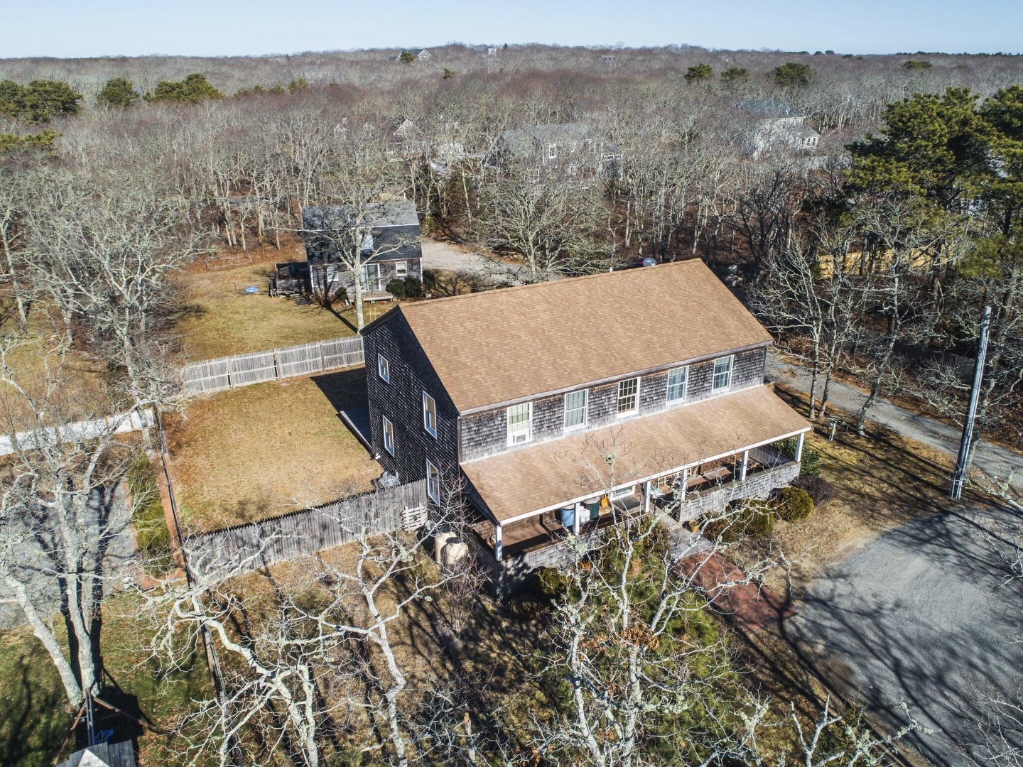 an aerial view of a house with a yard and large tree