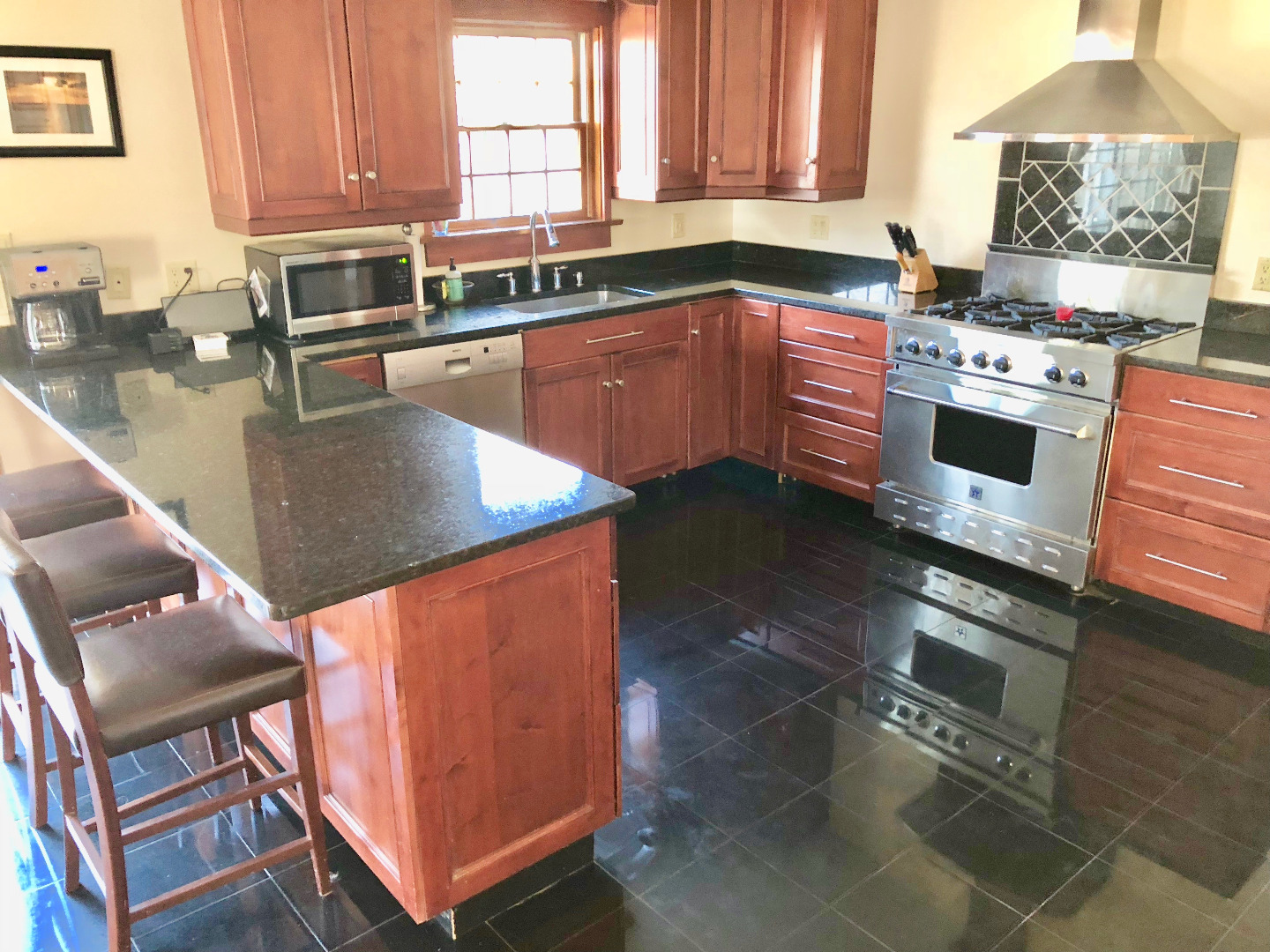 375 West Tisbury Road Edgartown, MA 02539 - Photo 12 of 32 a kitchen with stainless steel appliances granite countertop a stove a sink and a microwave