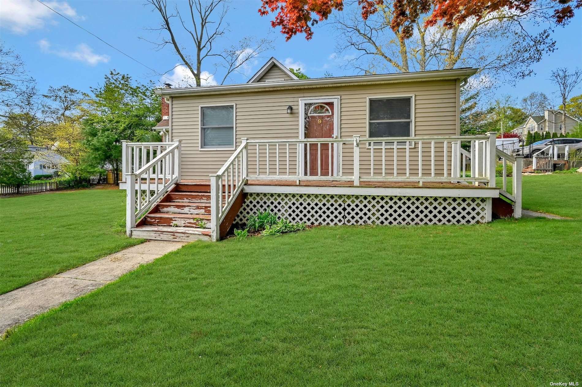 9 Shamrock Road Rocky Point, NY 11778 - Photo 1 of 1 a front view of a house with a garden