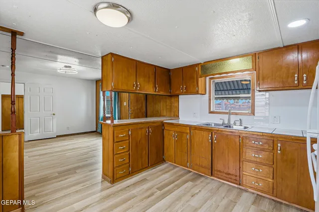 a kitchen with stainless steel appliances granite countertop a sink and cabinets