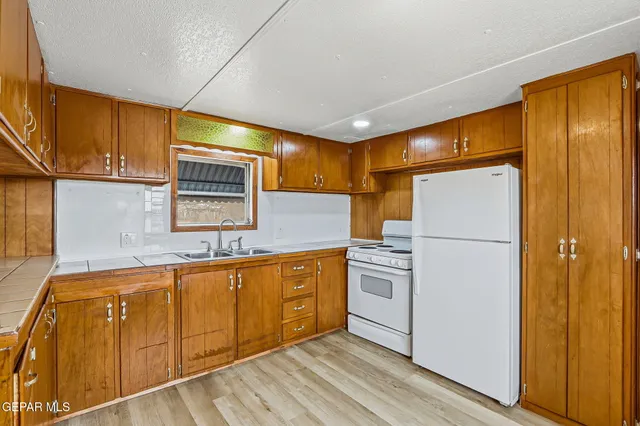 a kitchen with stainless steel appliances a refrigerator sink and cabinets
