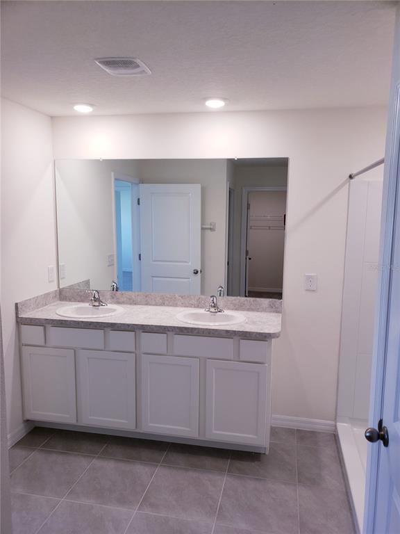 12211 Kingsley Trail Parrish, FL 34219 - Photo 20 of 28 a bathroom with a double vanity sink and a mirror