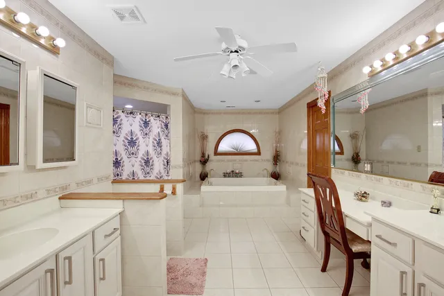 a spacious bathroom with a sink a mirror and a bathtub