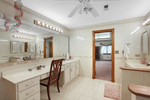 a spacious bathroom with a sink a large mirror and a shower