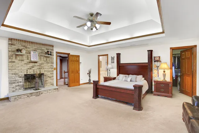 a spacious bedroom with a bed and ceiling fan
