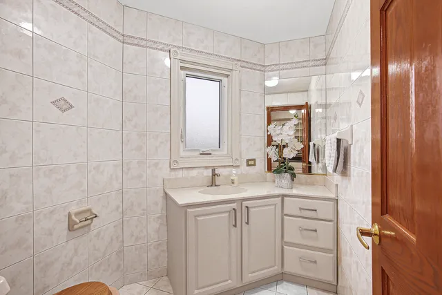 a bathroom with a sink shower vanity and a mirror