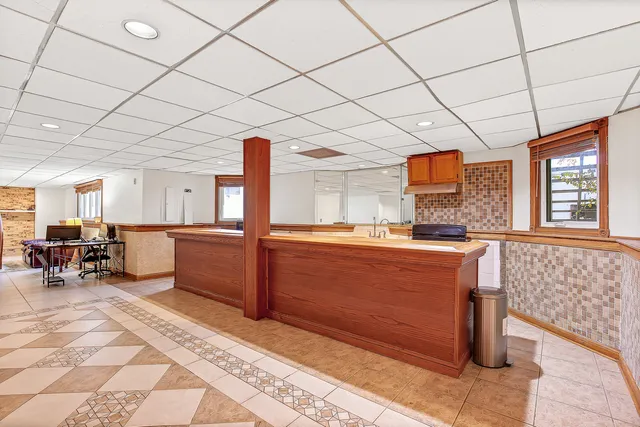 a room with gym equipment and large window