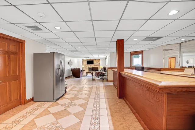 a large room with pool table and a large window