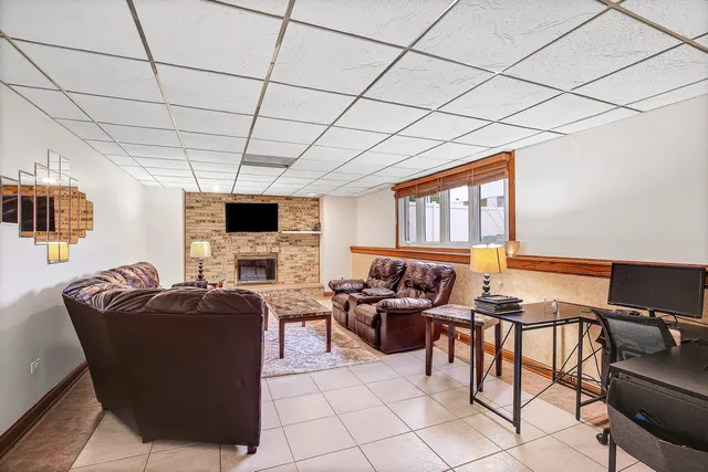 a living room with furniture a flat screen tv and a table