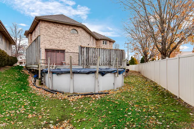 a view of a house with a wooden fence