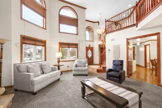 a living room with furniture a fireplace and a large window