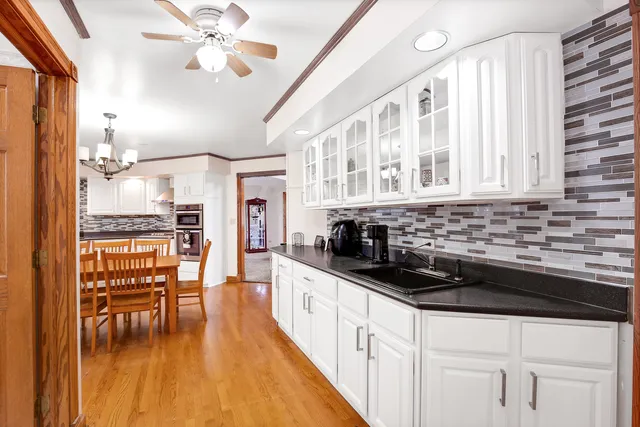 a kitchen with stainless steel appliances kitchen island granite countertop a stove a sink and a refrigerator