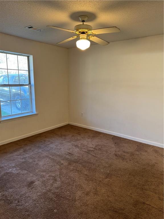 250 Countryside Lane Covington, GA 30016 - Photo 11 of 19 an empty room with windows and fan