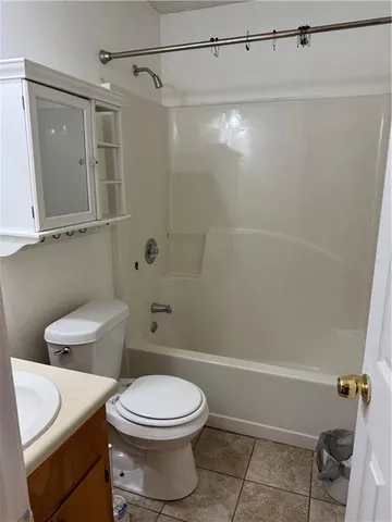 a bathroom with a toilet a sink and shower