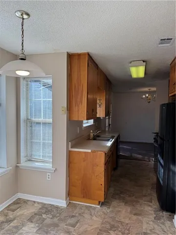 a kitchen with a stove and a refrigerator