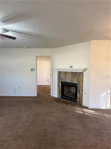 an empty room with a fireplace and window