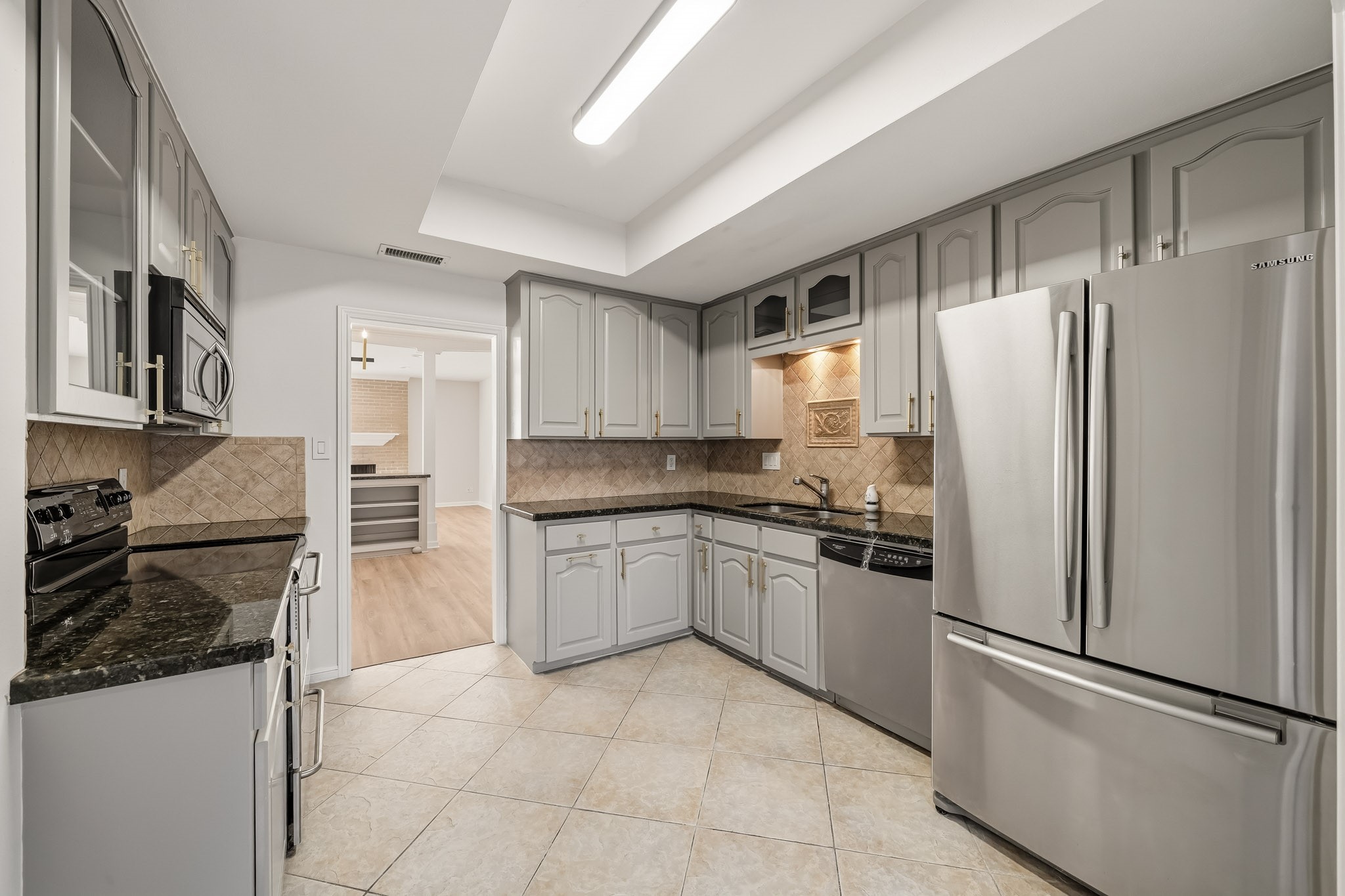 1746 South Gessner Road Houston, TX 77063 - Photo 8 of 25 Stylish kitchen with sleek stainless steel appliances, elegant granite countertops, and ample cabinet space for storage.
