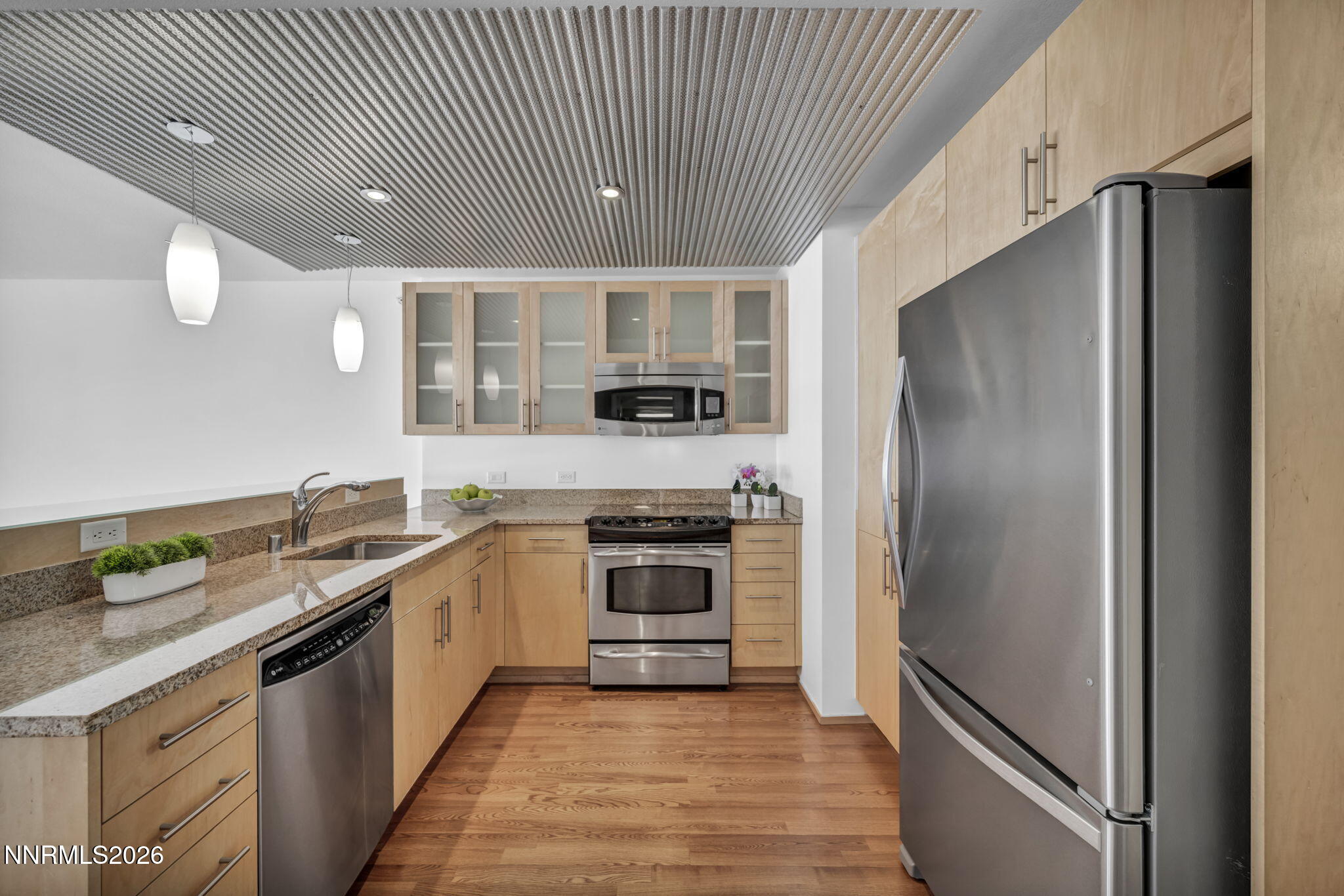 255 North Sierra Street, Unit 1208 Reno, NV 89501 - Photo 9 of 37 a kitchen with stainless steel appliances granite countertop a refrigerator and a sink