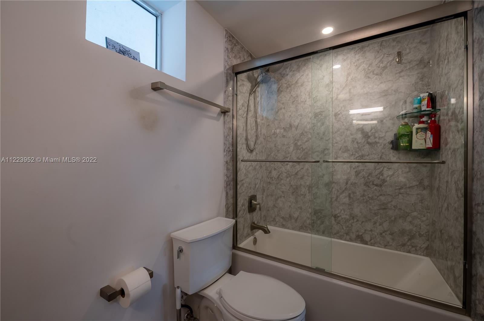 3339 Virginia Street, Unit 339 Miami, FL 33133 - Photo 8 of 13 a bathroom with a shower and toilet