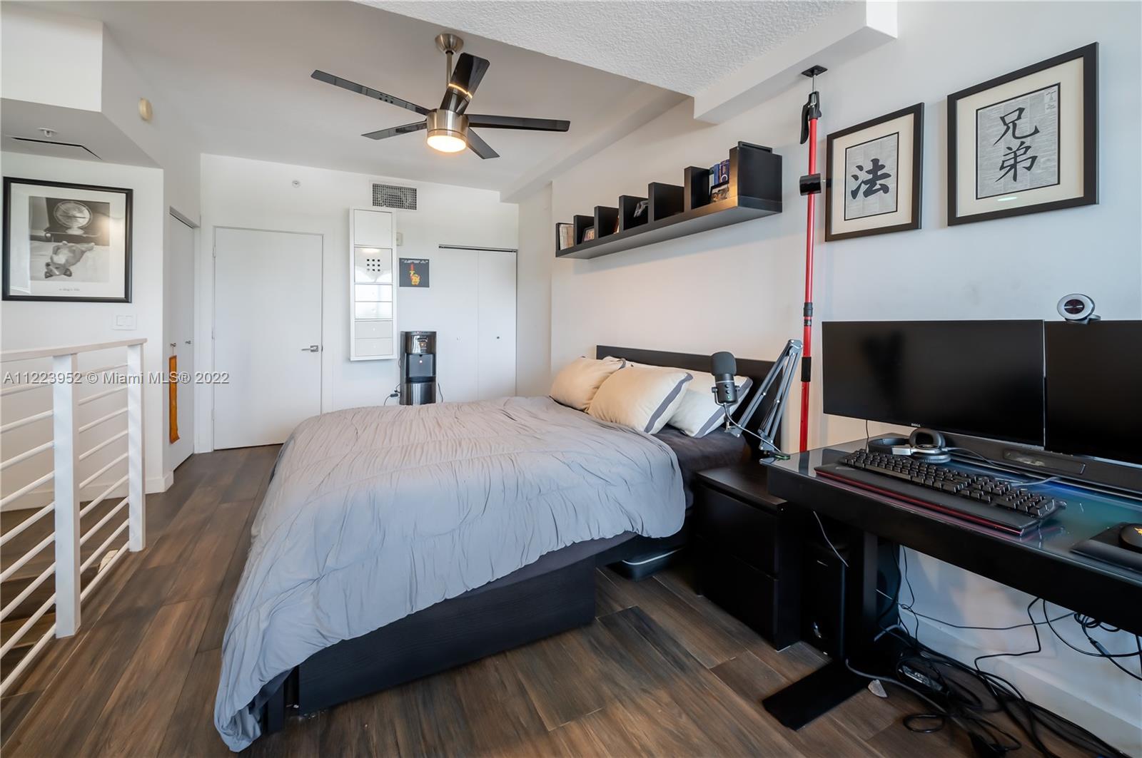 3339 Virginia Street, Unit 339 Miami, FL 33133 - Photo 10 of 13 a bedroom with a bed and a flat screen tv