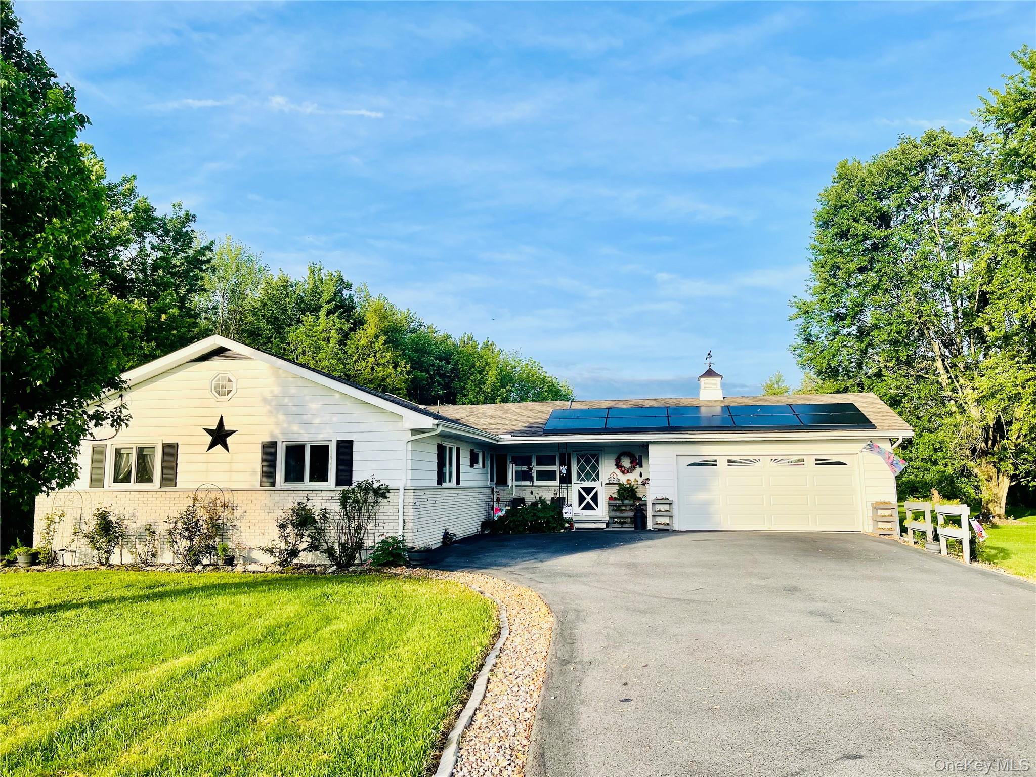 a view of house along with trees and yard