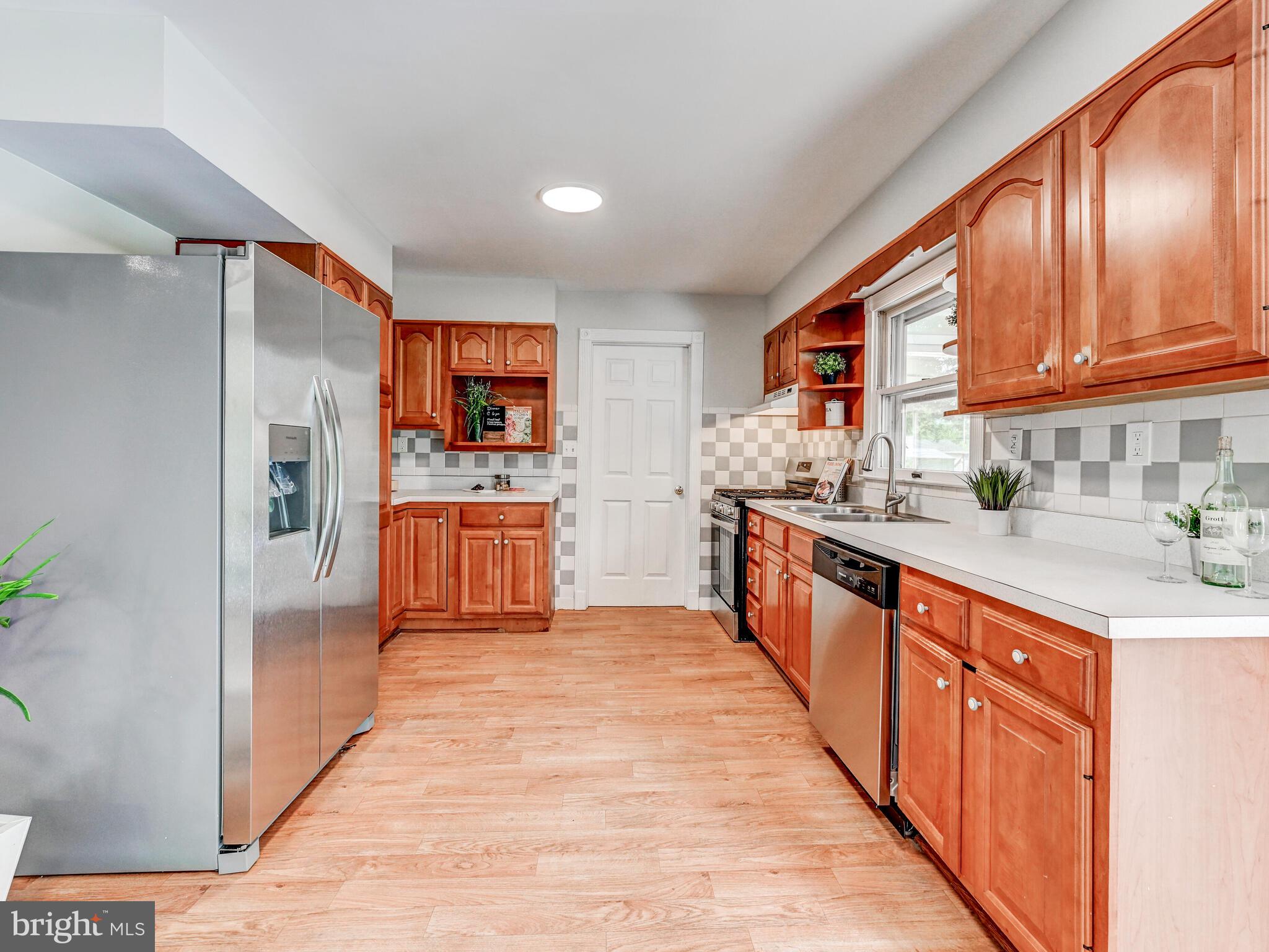 2411 Ruth Avenue Sparrows Point, MD 21219 - Photo 14 of 43 a large kitchen with stainless steel appliances granite countertop a stove a sink dishwasher and a refrigerator