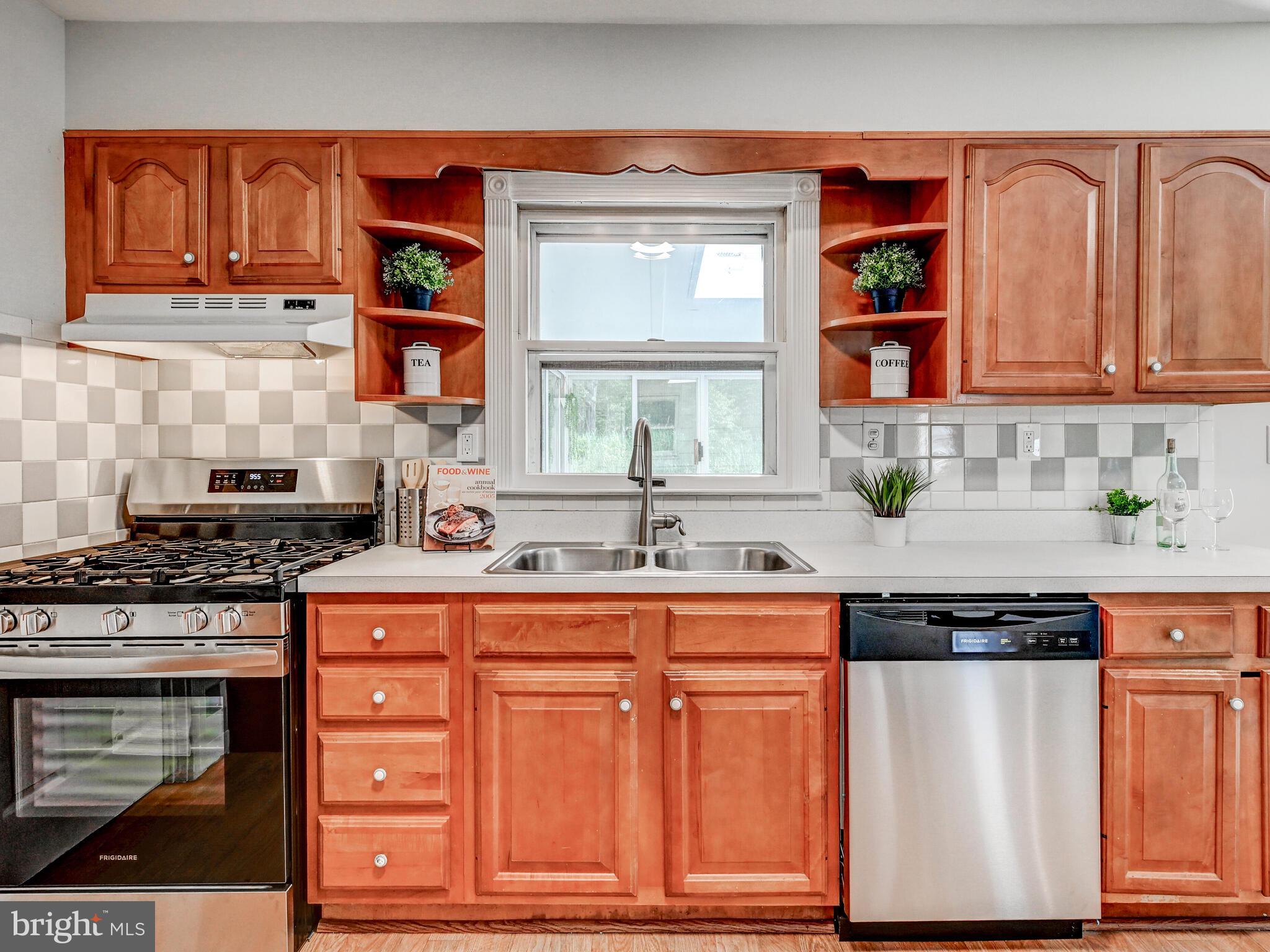 2411 Ruth Avenue Sparrows Point, MD 21219 - Photo 15 of 43 a kitchen with stainless steel appliances granite countertop a stove a sink and a microwave