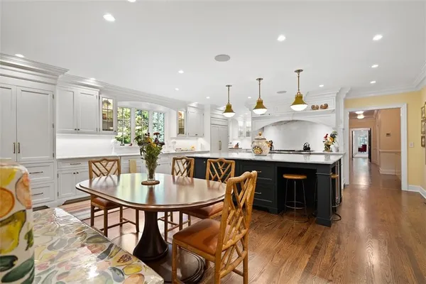 a kitchen with a table chairs and entryway