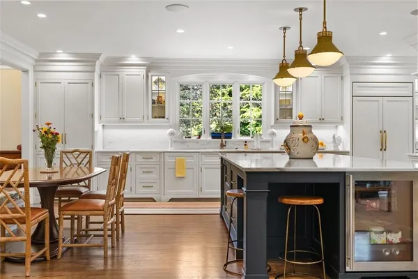 a kitchen with a sink dishwasher a stove and a refrigerator with wooden floor