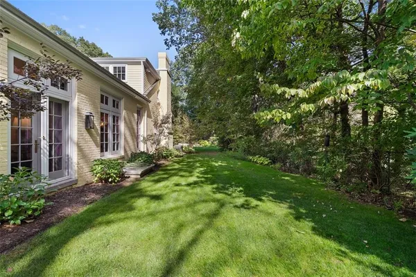 a view of backyard with outdoor seating and green space