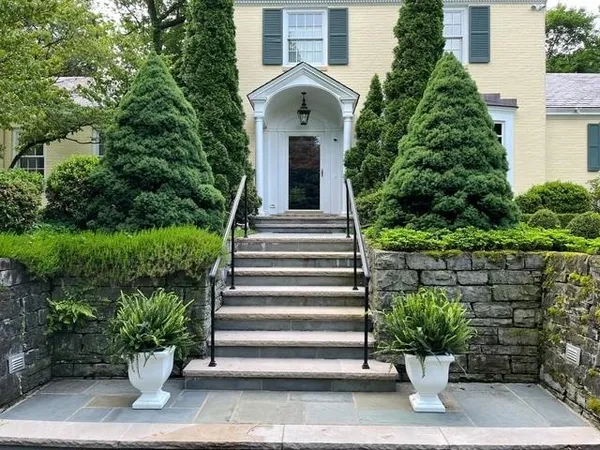 a front view of a house with plants