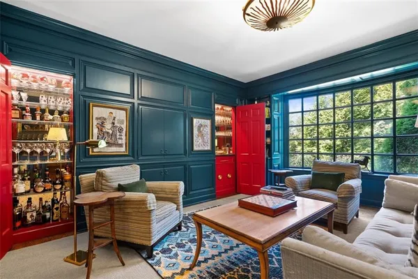 a living room with fireplace furniture and a large window