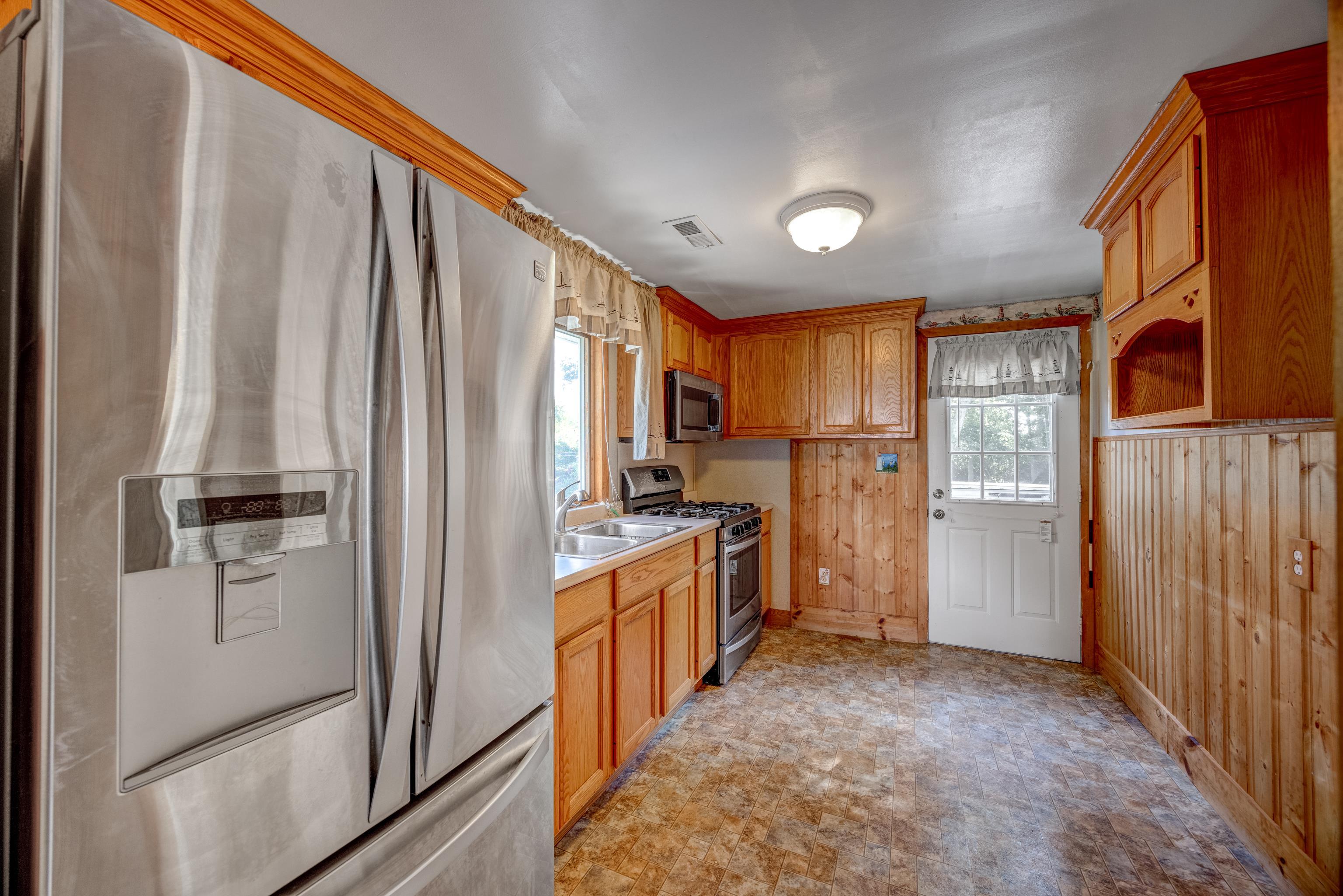 107 Rutledge Avenue Del Haven, NJ 08251 - Photo 9 of 24 a kitchen with stainless steel appliances a refrigerator and a stove top oven
