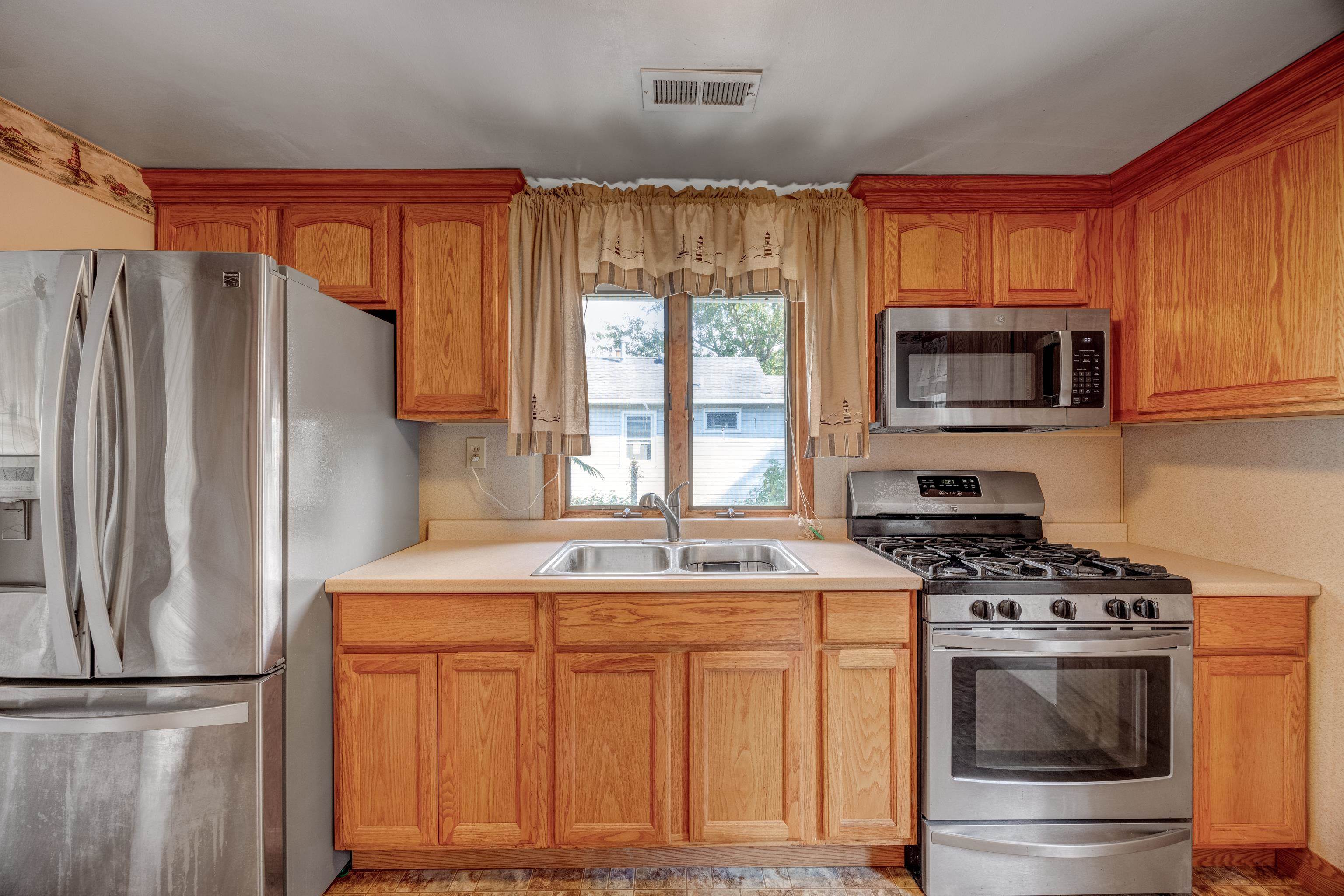 107 Rutledge Avenue Del Haven, NJ 08251 - Photo 10 of 24 a kitchen with stainless steel appliances granite countertop a refrigerator stove top oven a sink and dishwasher
