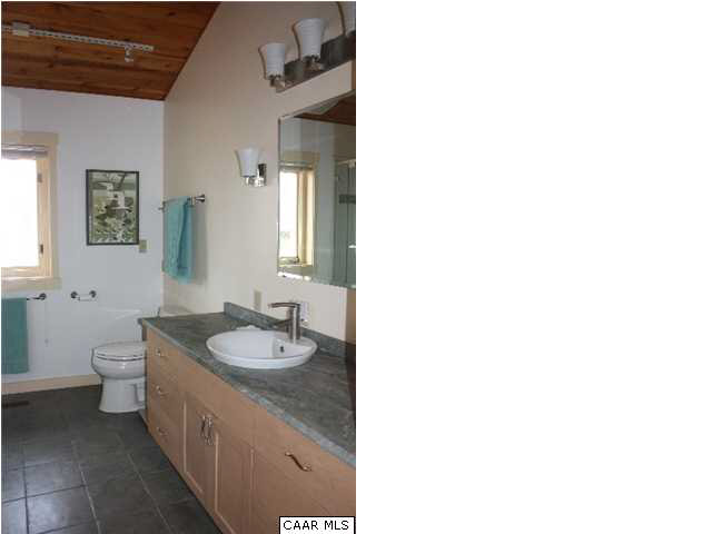 86 Rainbow Ridge Road Faber, VA 22938 - Photo 17 of 30 a bathroom with a granite countertop sink and a mirror