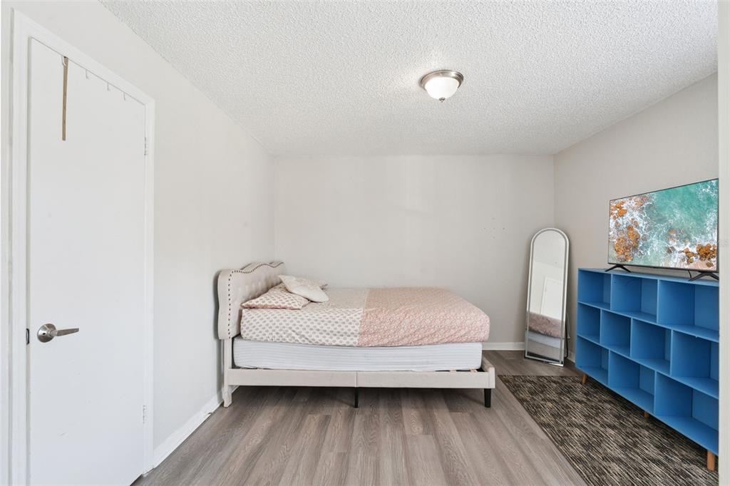 5120 Conroy Road, Unit 28 Orlando, FL 32811 - Photo 13 of 39 a bedroom with a bed and a dresser