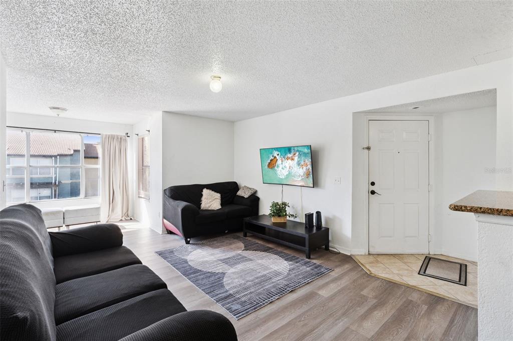 5120 Conroy Road, Unit 28 Orlando, FL 32811 - Photo 3 of 39 a living room with furniture window and wooden floor