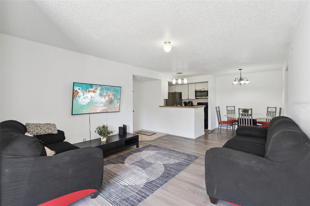 5120 Conroy Road, Unit 28 Orlando, FL 32811 - Photo 5 of 39 a living room with furniture and a flat screen tv
