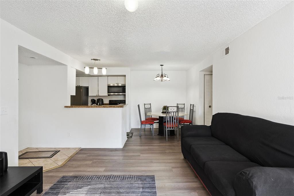 5120 Conroy Road, Unit 28 Orlando, FL 32811 - Photo 6 of 39 a living room with furniture and kitchen view